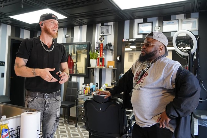 Zack working on a seated client inside the Ego Cutz shop