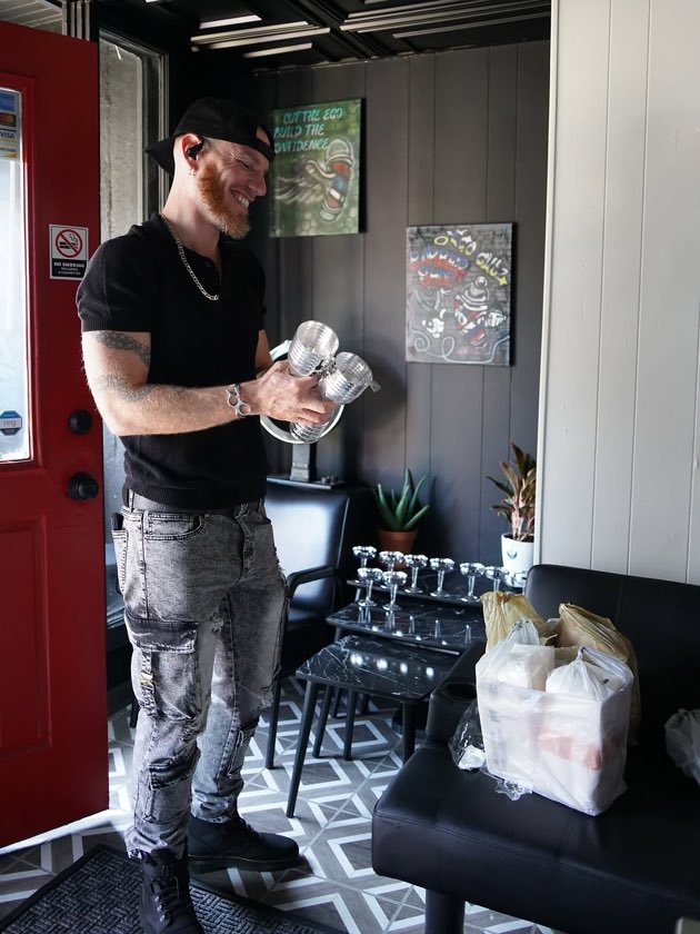 Inside Ego Cutz with Zack, a client, and the shop at work